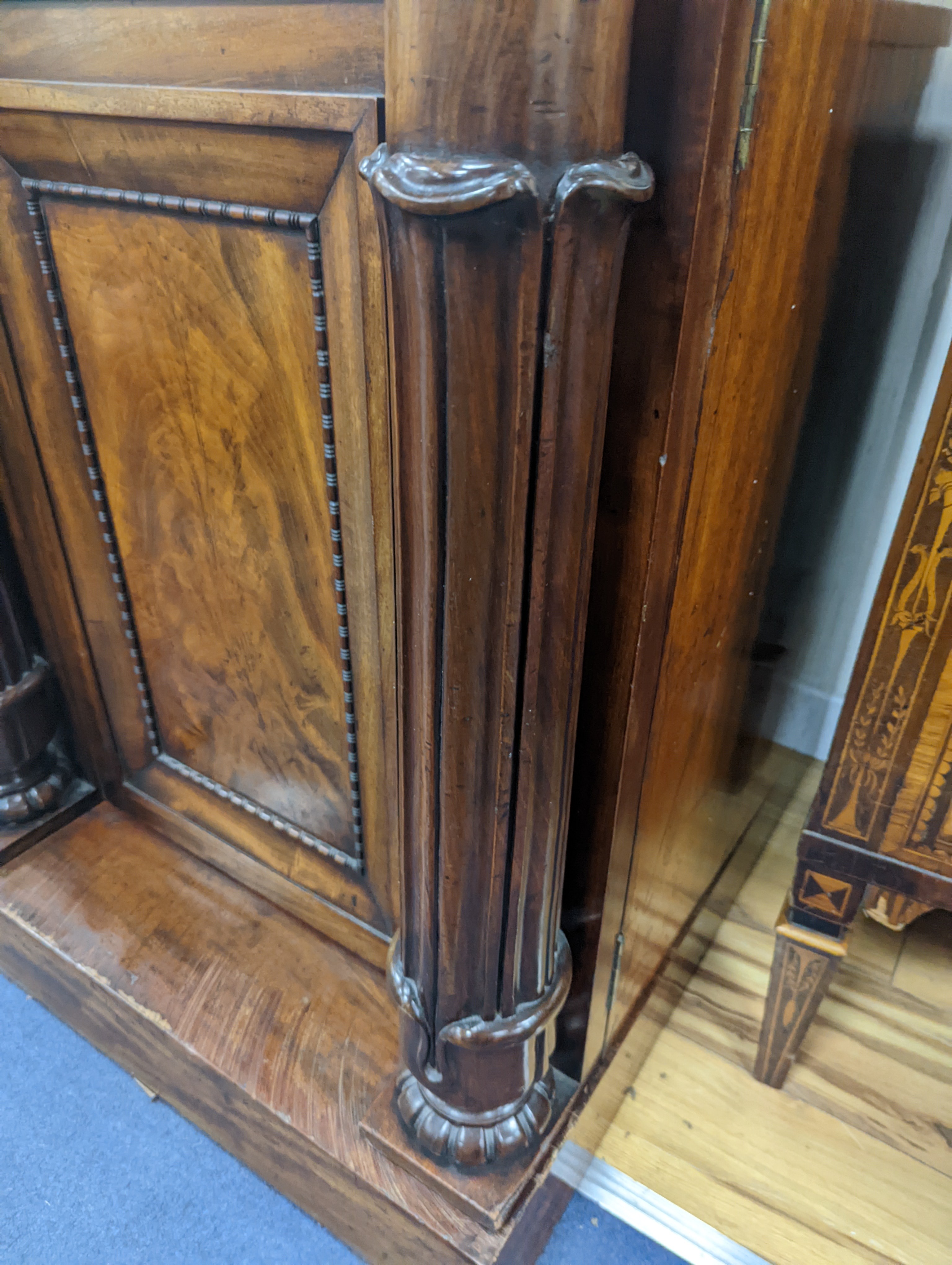 A William IV figured mahogany inverse breakfront compactum wardrobe, length 263cm, depth 70cm, height 197cm